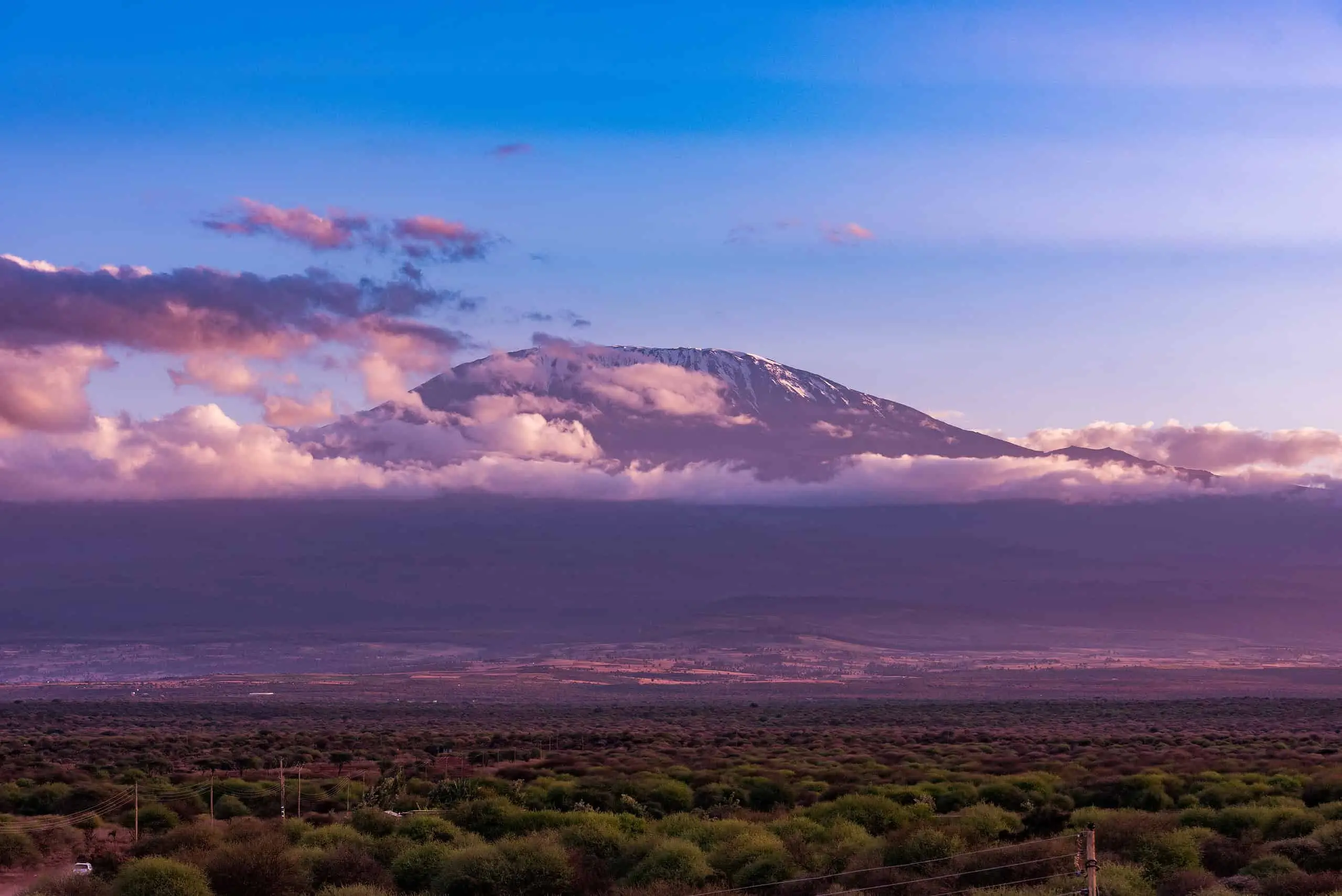 Snow-capped Mount Kilimanjaro at sunset with clouds