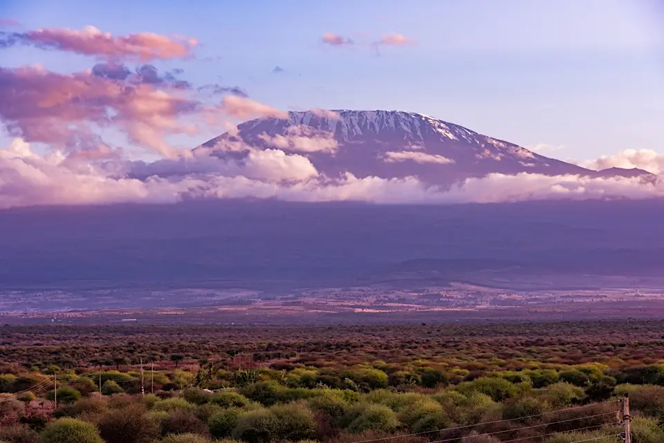 Snow-capped Mount Kilimanjaro at sunrise with clouds