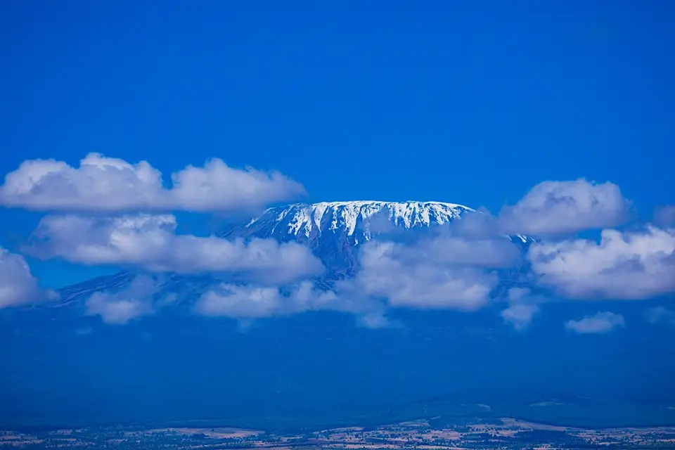 Snow-capped Mount Kilimanjaro above clouds