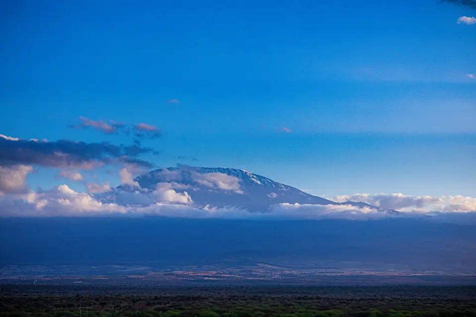 Snow-capped mount Kilimanjaro under blue sky at sunset